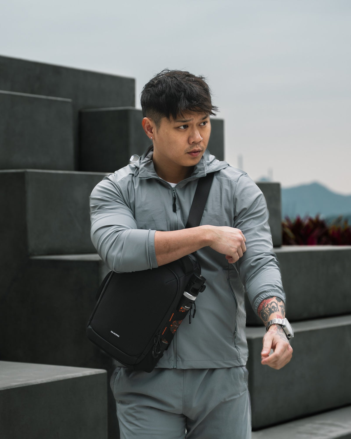 The Smorky Sling 6L in Stealth Black — worn on location